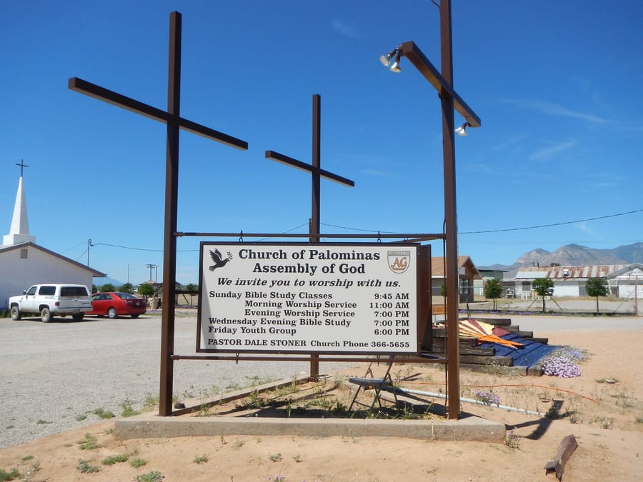 Church of Palominas road sign, with service times